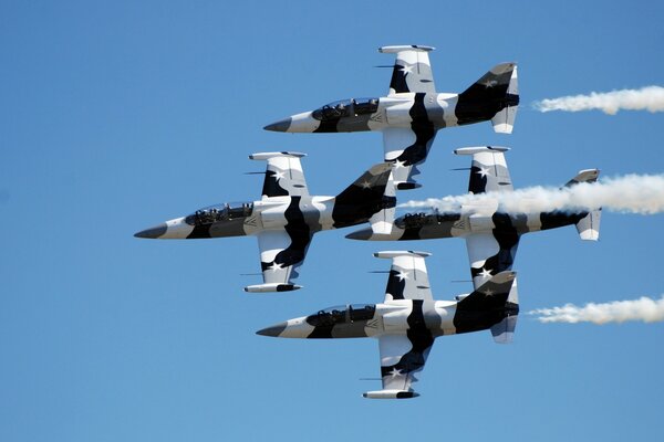 Four planes flying in the blue sky