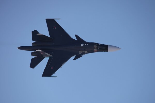 Su-34 fighter in flight against the blue sky