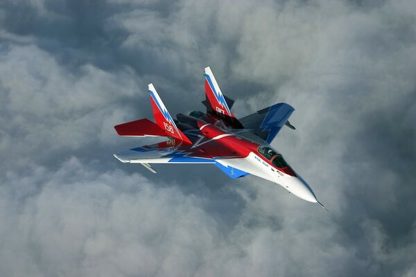 Mi-29 fighter over clouds in the sky