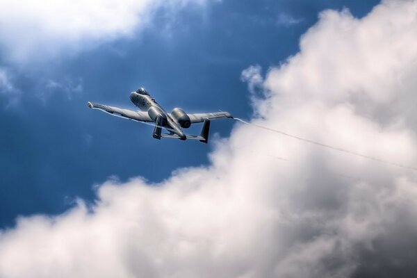 The a10 plane takes off against the backdrop of beautiful clouds