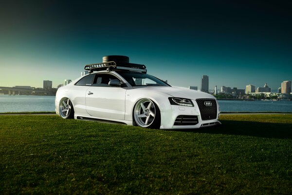 White audi rs 5 stancenation on green grass