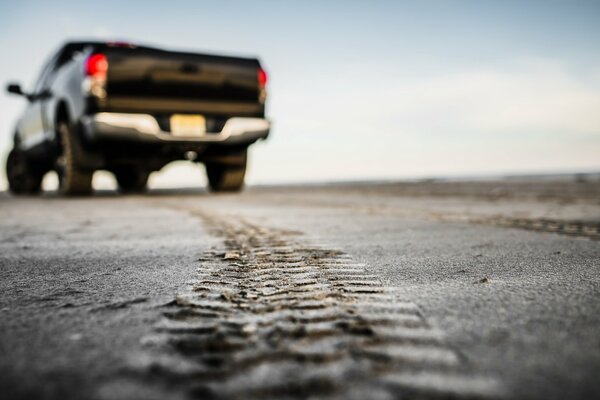 The footprint of a car on a country road