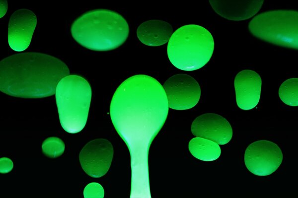 Bright green bubbles on a black background