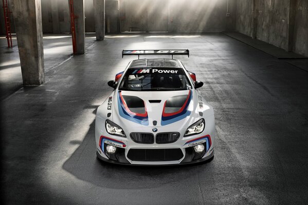 Белый спортивный bmw m6 gt3 2015 года на парковке