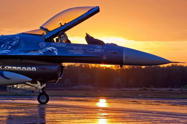 Fighter jet on the background of a sunset