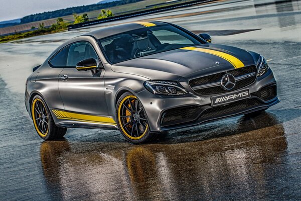Mercedes black car with yellow stripe