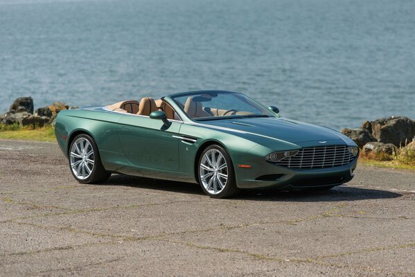 Green convertible on the seashore