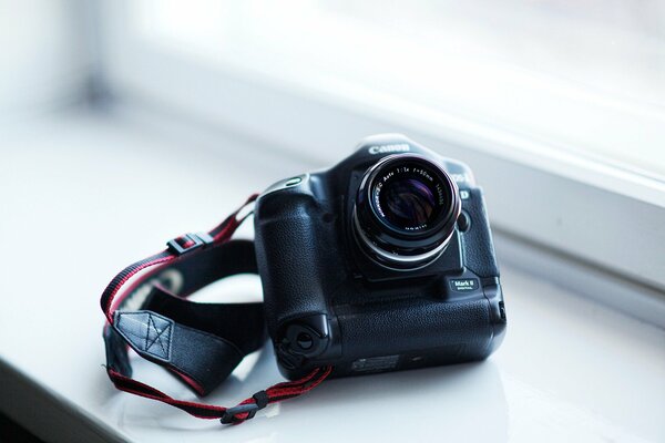 A camera on a white windowsill