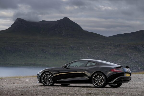 Aston Martin 2014 negro cerca del lago