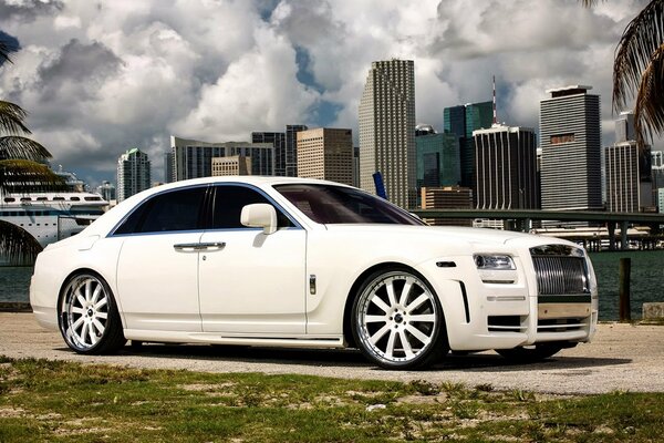 White Rolls-Royce phantom on the background of skyscrapers