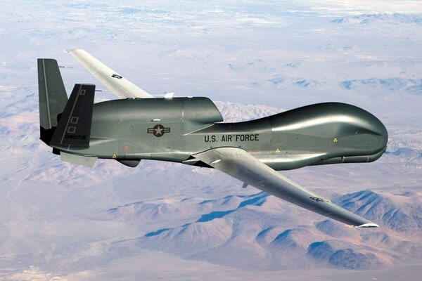 An unmanned aircraft flying over the desert drone