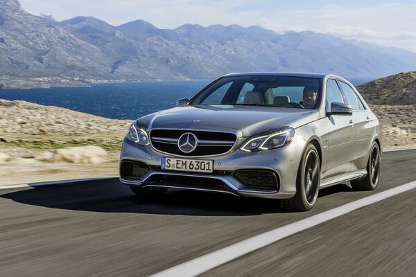 Silver Mercedes in motion against the background of the sea