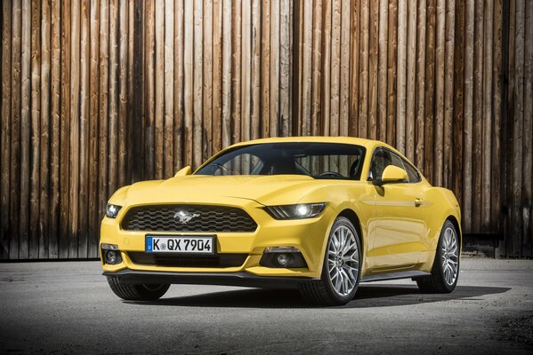 Yellow car on a wooden background