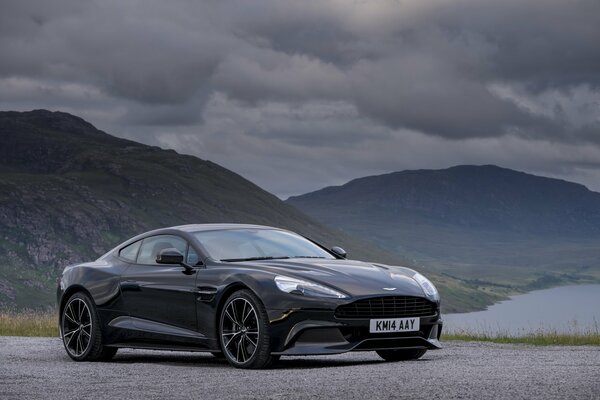 Black sportian car on the background of mountains