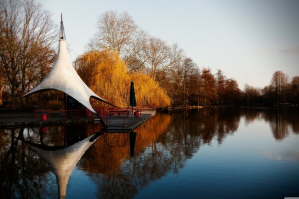 Gazebo on the banks of the autumn river