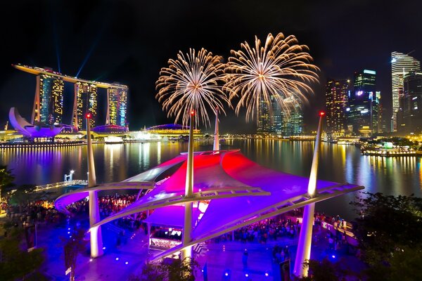 At night in Singapore , Marina bay sands showed fireworks