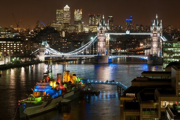 Multicolored ship with tourists on the night river