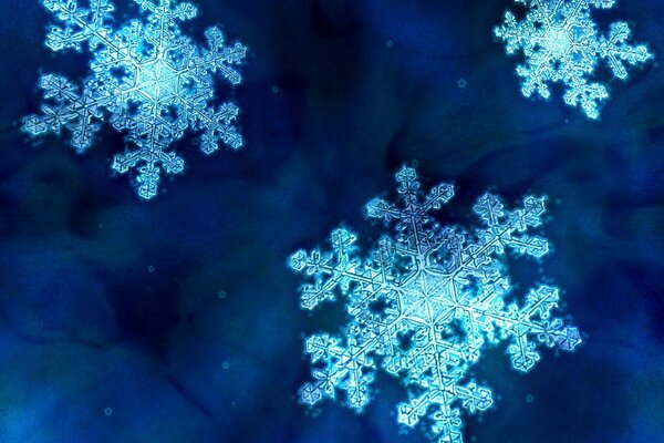 Hermosos copos de nieve sobre fondo azul