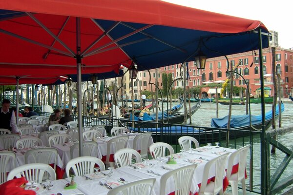 Floating cafe in Venice and gondolas