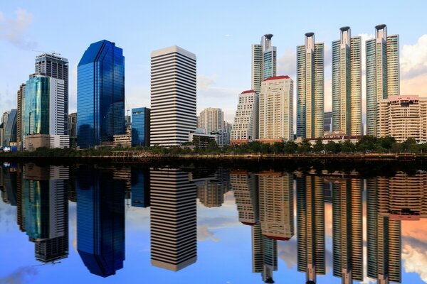Skyscrapers are reflected in calm water
