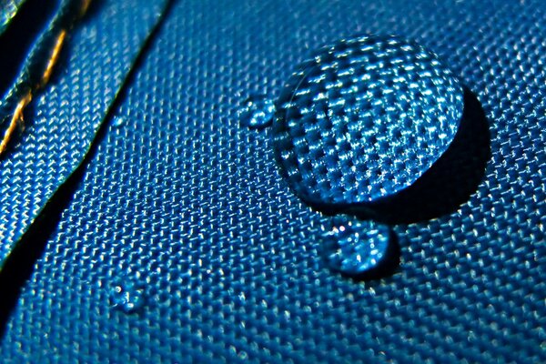 Blue drop on fabric close-up