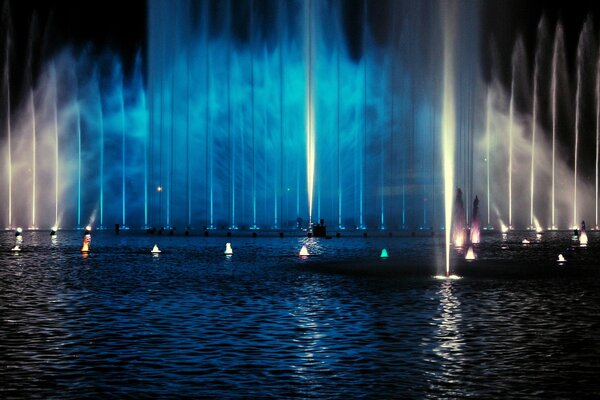 Blue high fountain on the water