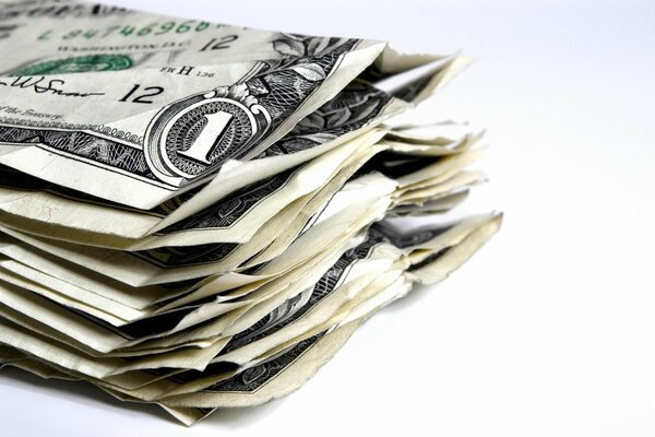 A wad of crumpled money on a white background