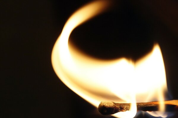 A burning match in a yellow flame