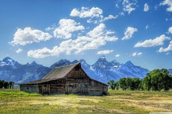 Sunny landscape of a barn in the mountains
