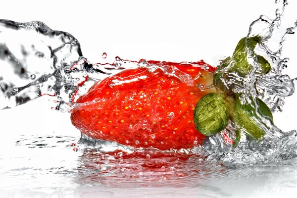 Bright strawberries in a splash of water