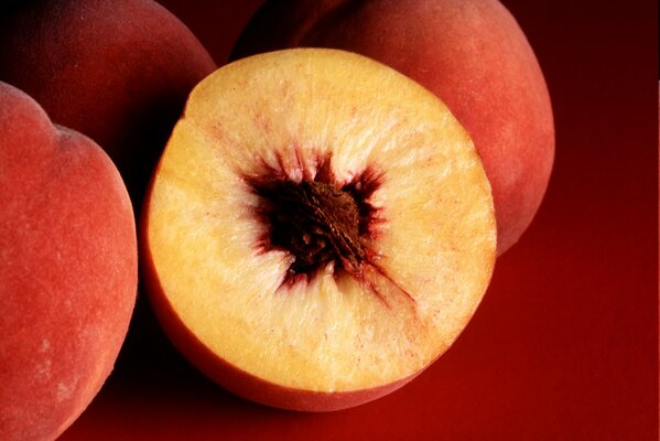 Sliced peach on a red background