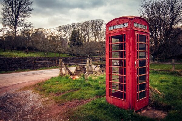 The red booth stands on the green grass