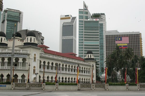 White palace in the middle of the square against the backdrop of skyscrapers