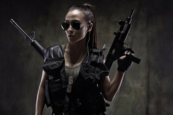 Beautiful brunette with a gun in dark glasses