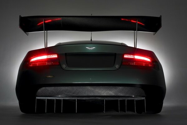 Rear side of the car, burning headlights and spoiler
