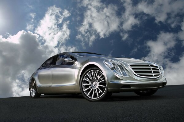 Silver Mercedes against a cloudy sky