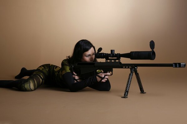 Sniper girl in camouflage with a screw