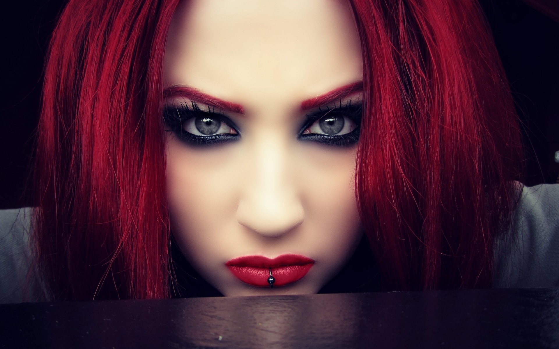 a woman girl piercing red black close up face