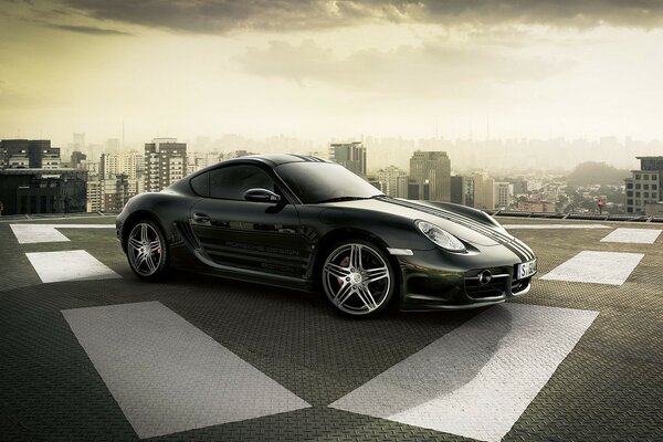 Sports car on the roof of a skyscraper