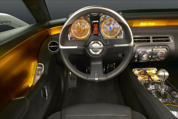 The interior of the car in black and gold