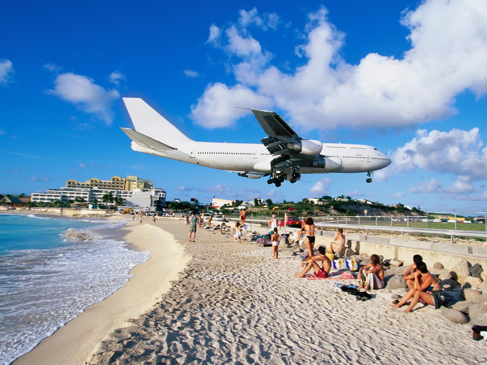 plane beach sky crowd