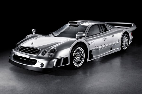 Silver mercedes-benz on a black background