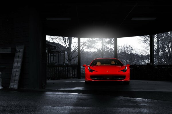 Un ferrari rojo brillante en el centro de una foto en blanco y negro