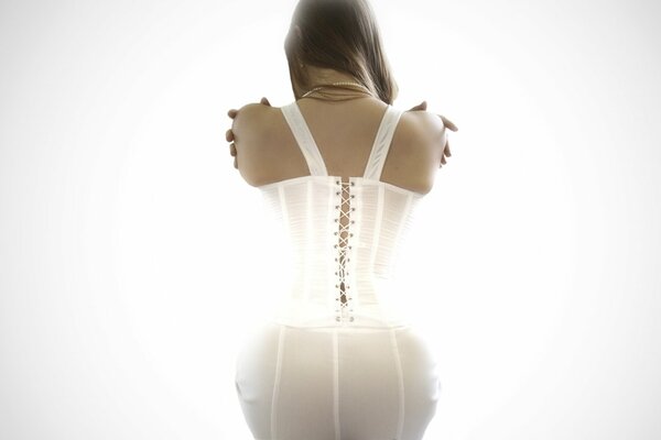 A girl in a white corset with a gorgeous figure