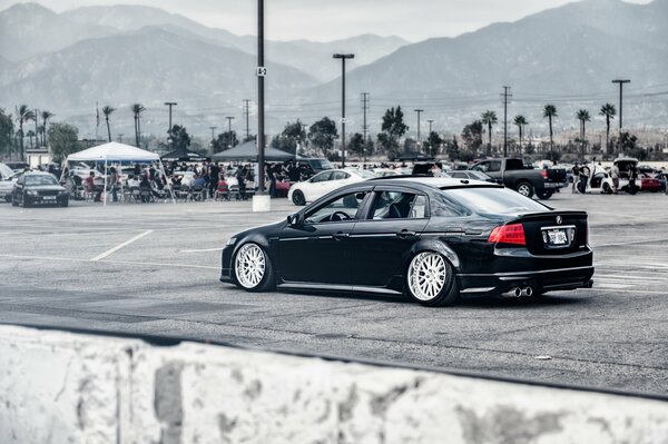 A black Honda accord with tuning is driving around the city