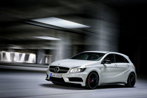 Mercedes in motion in an underground parking lot