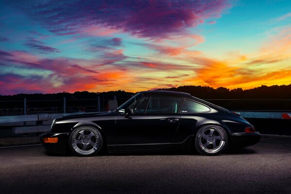 Classic black Porsche at sunset
