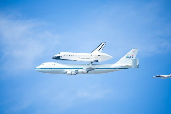 The shuttles of the planes are visible in the clear bright sky