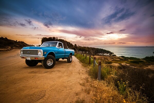 Chevrolet pickup truck on the background of the sea and beautiful clouds
