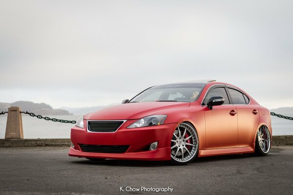 A tuned Lexus car on the background of a lake